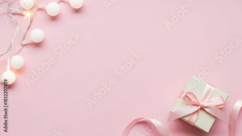 Pastel pink background with a tiny gift and ribbon combo in the lower-right corner, soft scattered white Christmas lights on the upper-left side, large centered copy space.