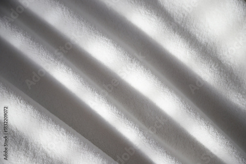 Plush white velour blanket. Ideal for cozy warmth and home decor. Adds luxury comfort to any interior