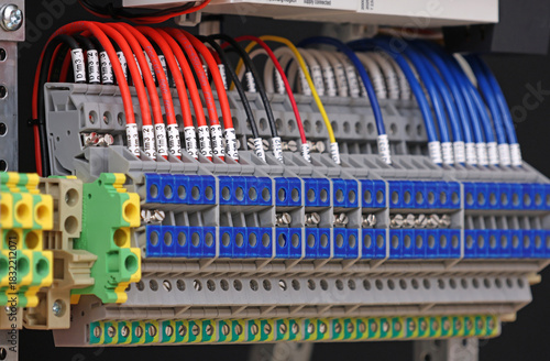 Electrical screw terminals for connecting wires in an electrical switchboard. Soft focus. Close-up.