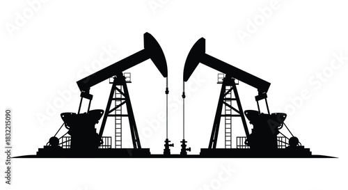 Two oil pumps standing against a plain white background a striking industrial silhouette