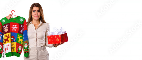 Ugly Xmas sweater. Christmas person with bad gift. Christmas woman with bad gift. Woman reacting to bad Christmas gift. Copy space.