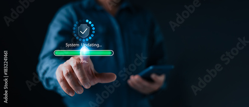 A person touches a glowing digital progress bar showing system updating at 99% highlighting cybersecurity software maintenance and modern tech reliability in a dark interface focused environment.