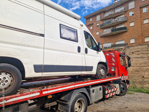 Broken down camper van on a tow truck