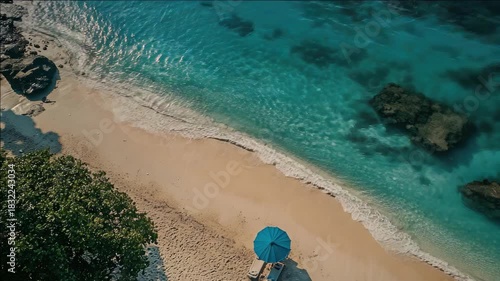 Bright blue lagoon with light colored sand and clear waters on sunny day.