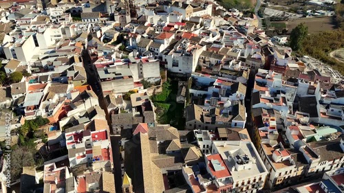 Aerial close view of Puente Genil old town Andalusia Spain with church tower narrow streets and white houses showing traditional southern Spanish architecture
