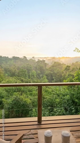 Luxurious Glamping Tent Bedroom with Balcony Overlooking a Serene Jungle Sunrise