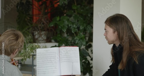 Male Teacher Gives Music Lesson for a Child. Man is Teaching Kid to Play Musical Instrument. 4K 10-bit