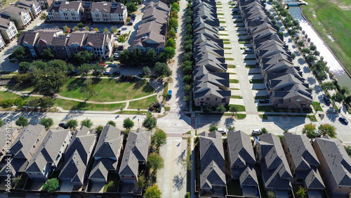 Mixed of residential houses and multi-story apartments rental units with parking lots near central park, canal, illustrating layered residential zoning, land use diversity in Flower Mound, Texas