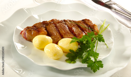Grilled beef steak with boiled potatoes and parsley