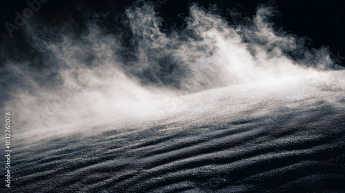 Dramatic dust or snow blowing across a dark, textured landscape.