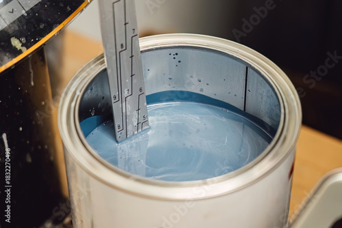 Obraz na plátně Careful mixing and measuring of automotive paint in a can for precise color matching