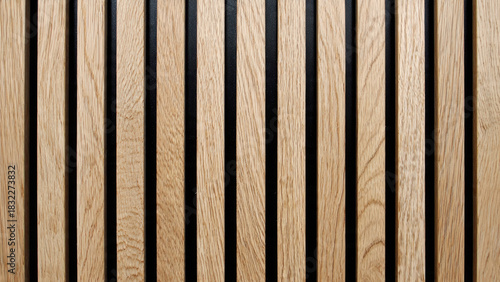 Close-up of modern acoustic wood paneling featuring light vertical timber slats on a dark background, creating a stylish textured wall design.