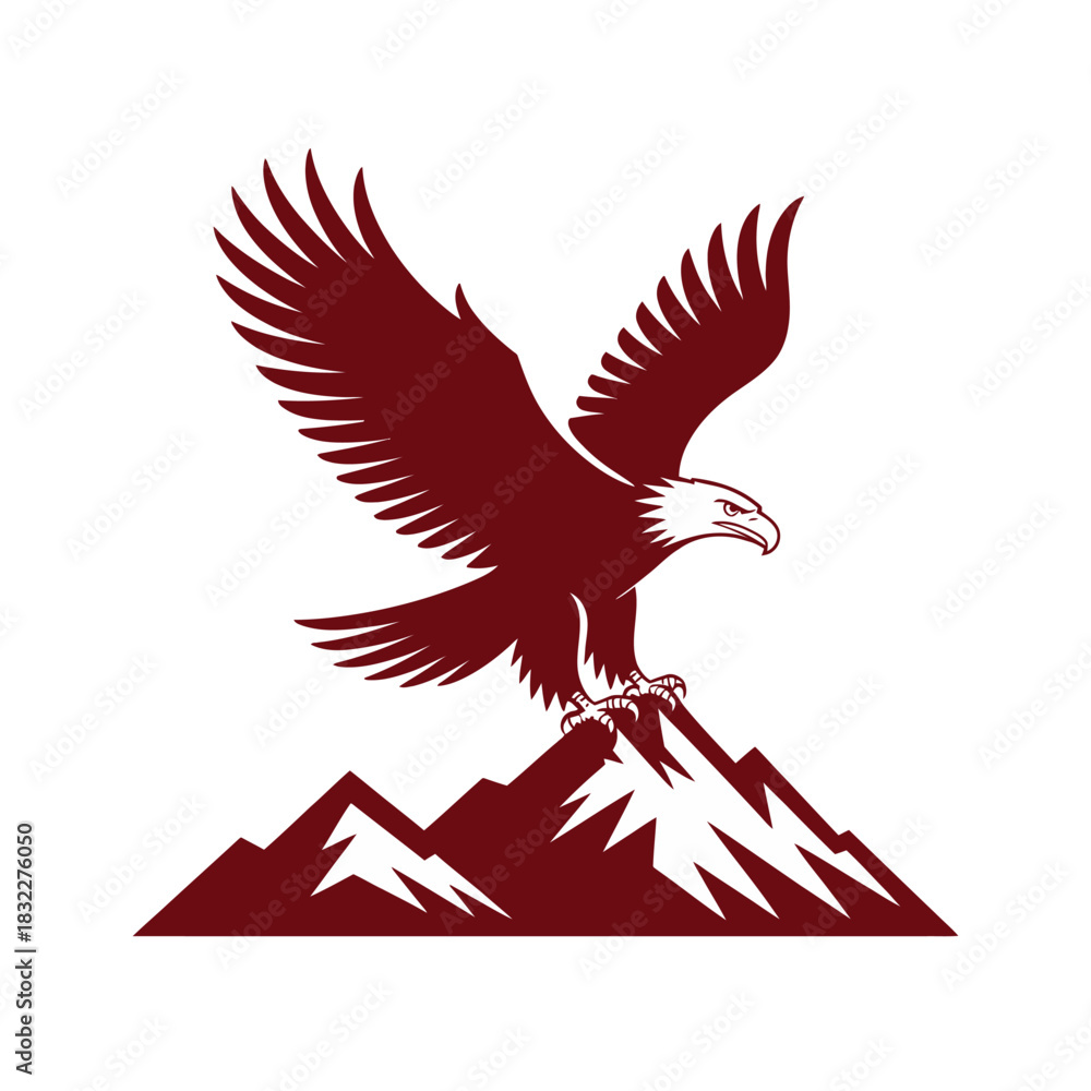 Obraz premium A majestic eagle with outstretched wings perches atop a snowy mountain peak.