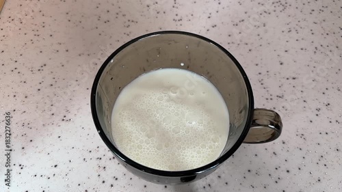 Wallpaper Mural Milk is poured into a mug. A drop of milk falls into the glass. Slow motion Torontodigital.ca