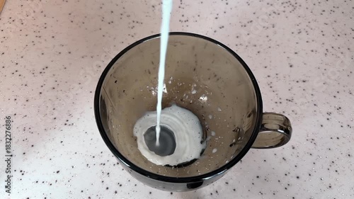 Wallpaper Mural Milk is poured into a mug. A stream of milk fills the glass. Slow motion Torontodigital.ca