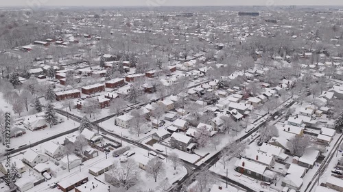 Upper class American suburban suburb near Columbus, Ohio in middle class neighborhood with homes, townhouses, houses, streets, and roads during a wintry and snowy winter storm with cold snow and ice