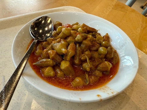 Bamya Turkish traditional food. (Turkish cuisine) Homemade Food Okra in Plate. Organic Food. Etli bamya yemegi.