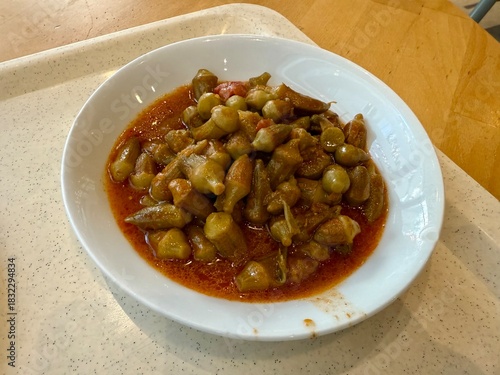 Bamya Turkish traditional food. (Turkish cuisine) Homemade Food Okra in Plate. Organic Food. Etli bamya yemegi.