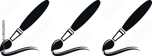 Three paintbrushes with paint strokes isolated on transparent background