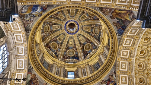 Vatican City, Rome - 12 January 2025. A dome ceiling with vibrant frescoes, golden trim, and Latin inscription frames circular medallions and biblical scenes in radiant detail.