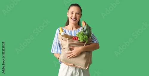 Young Asian woman with groc...