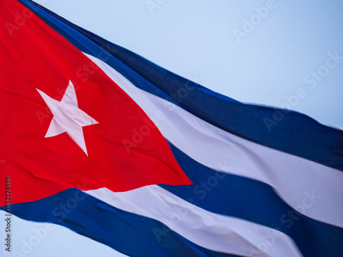 Cuba Flag Waving on flagpole. Cuba flag flaping in wind. Close-up of an Cuban flag flying in the wind against a background of clear sky. Cuba flag Dramatic look, bottom view
