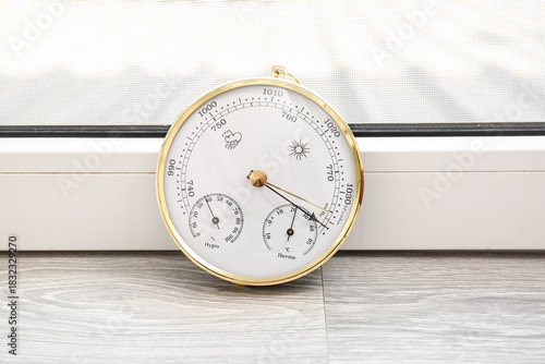 Aneroid barometer on windowsill, closeup