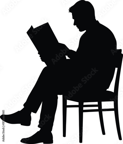 Silhouette of man reading newspaper while sitting on chair