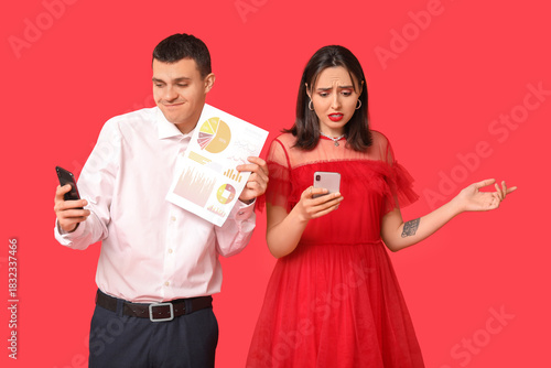 Young couple holding mobile...