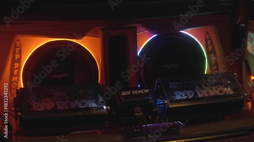 This video shows a colorful, light up sound system with booming speakers in the back of a car.