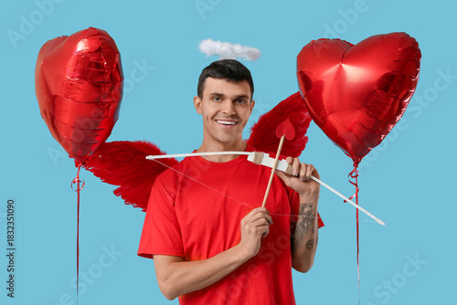 Young man dressed as Cupid ...