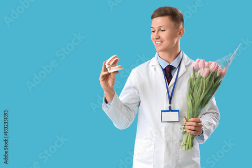 Male dentist with tulips an...