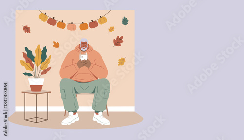 Elderly man relaxing at home using smartphone during the cozy fall holiday season