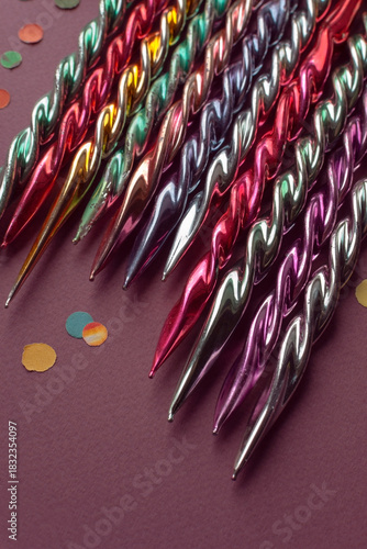 Fragment of old vintage Christmas ornaments glass icicles, close-up top view on purple background, selective focus