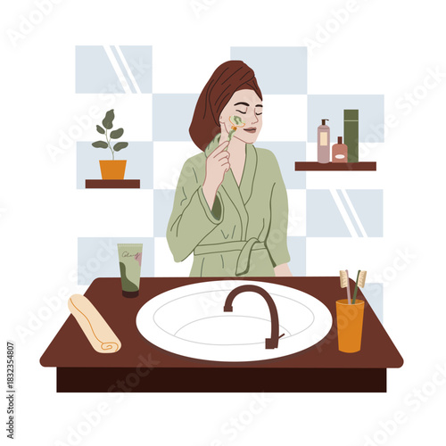 Self care, skincare routine, and beauty rituals concept. Woman in a bathrobe  massaging her face with a jade roller. 