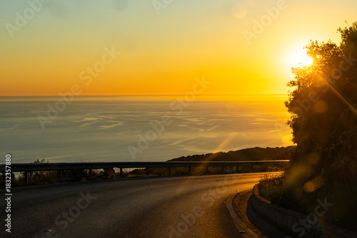 Turn of a mountain road along the Mediterranean sea coast during sunset in a nice summer evening