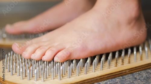 close-up of a woman's feet standing on a board Sadhu