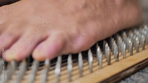 Slider Shot close-up of man's feet standing on Sadhu board