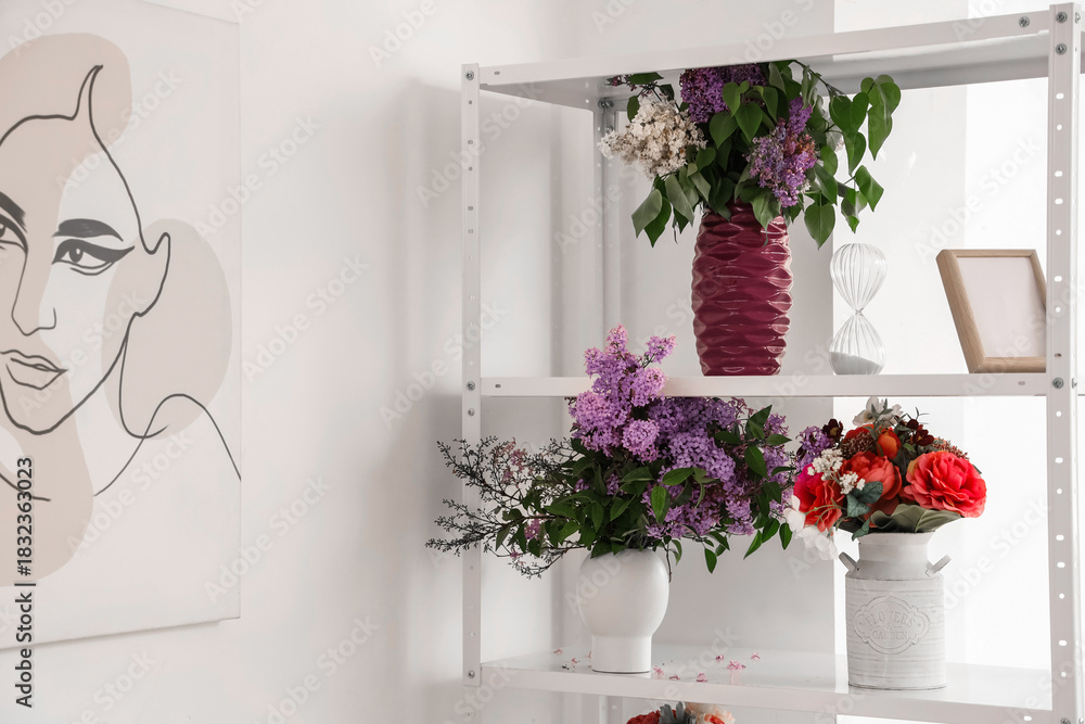 Fototapeta premium Vases with lilacs in florist studio