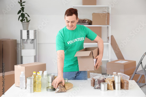 Male volunteer donating foo...