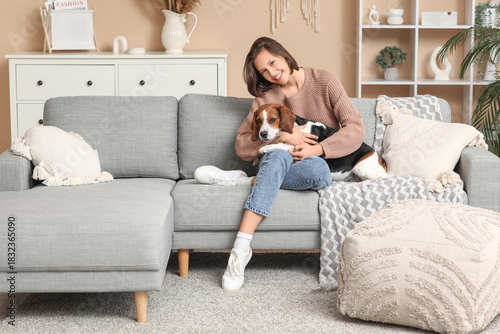 Young woman with cute Beagl...