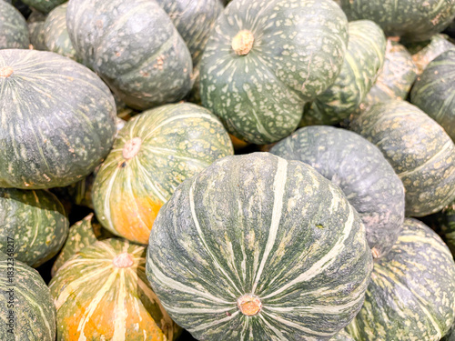 Pumpkins in the store in various colors and shapes for the Halloween holiday