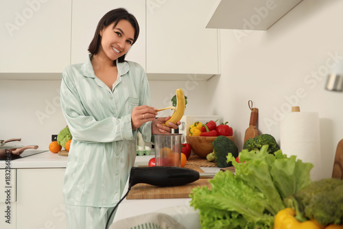 Young woman with blender pe...