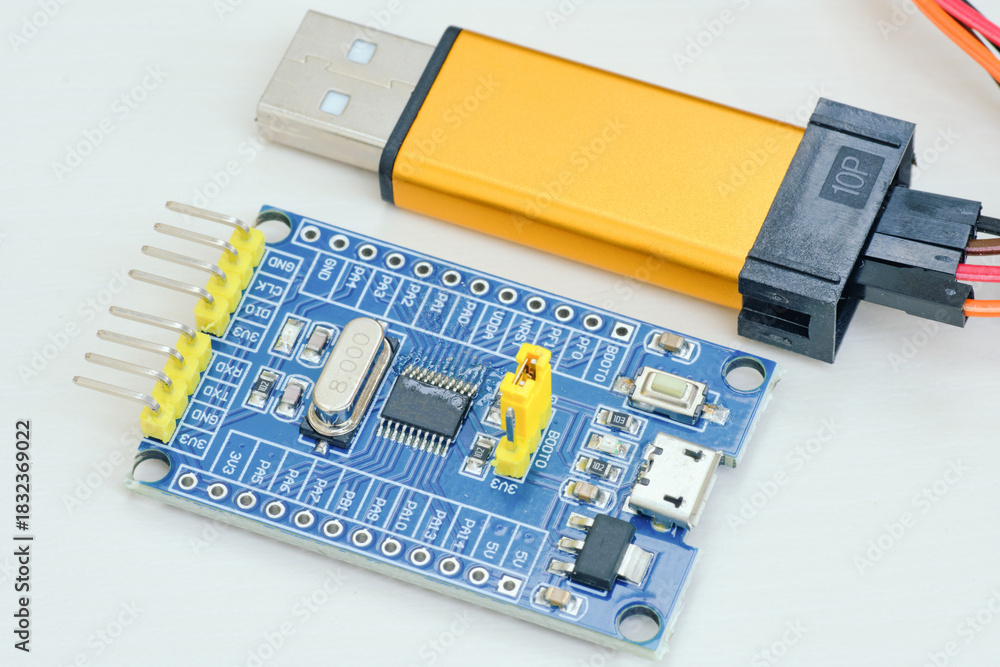 Fototapeta premium Programming board of Arduino UNO in blue colour isolated in white background