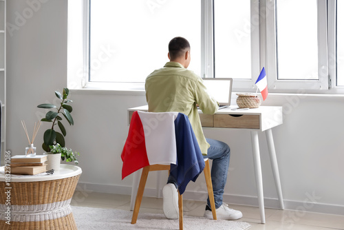 Young man with laptop and f...