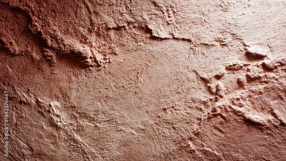Fototapeta premium Abstract close-up of a deeply textured reddish-brown surface, resembling rough stucco or weathered rock, with dramatic light and shadow.