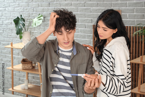 Shocked young couple with p...