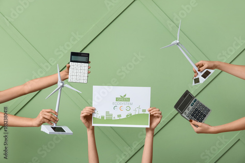 Many hands with wind turbin...