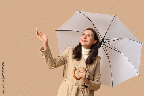Happy young woman with umbr...