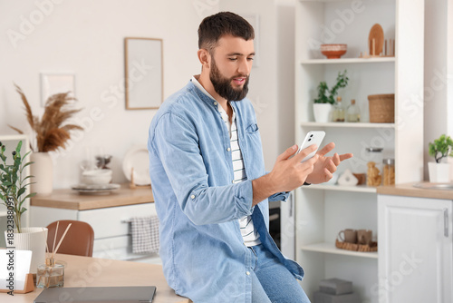 Young bearded man working w...